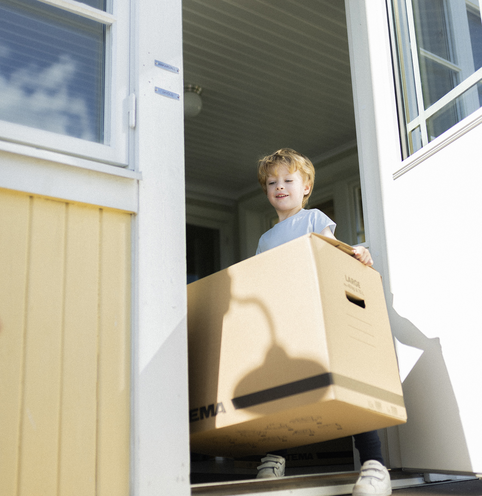 pojke med flyttkartong